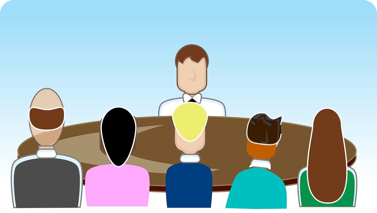 Job interview in progress. One candidate sat opposite 5 members of an interview panel.