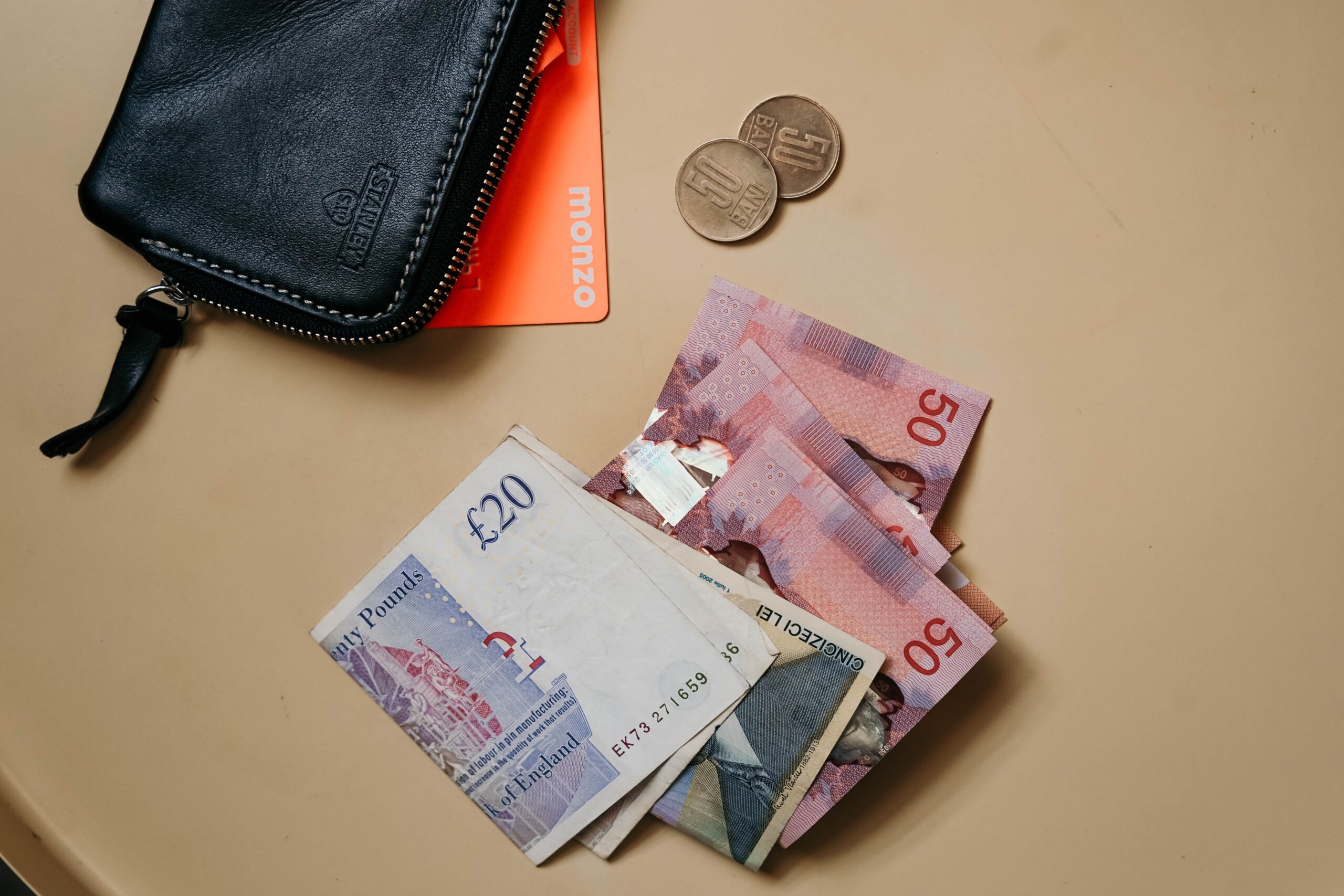 £20 and £50 notes, with an open wallet and a Monzo bank card