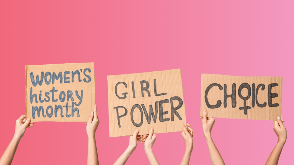 signs saying 'women's history month', 'girl power' and 'choice'